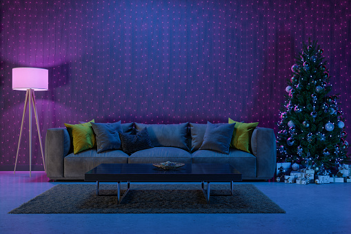 Living Room Interior Decorated For Christmas With Christmas Tree, Ornaments, Gift Boxes And Sofa At Night With Neon Lighting