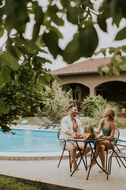 istock Young couple sitting in the backyard 1439719086