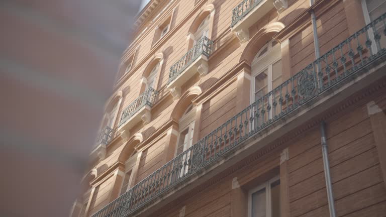 Discovery of a typical alley in downtown Toulouse, with these ochre walls, in France