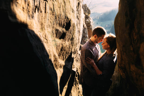 Sentimental happy couple in love bonding surrounded by rocks