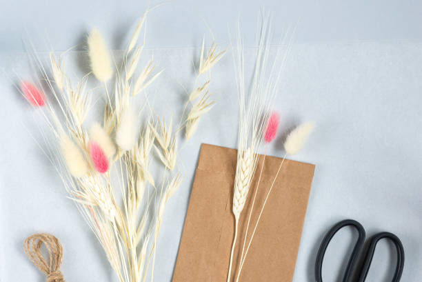 istock Basic set for simple home-made beautiful pink bouquet of dried flowers at the master class. Idea for a hobby, business. Making trendy eco diy of long standing flowers on light background 1439723185