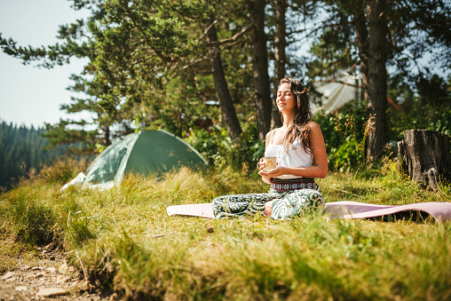 Young woman enjoying morning in the nature.