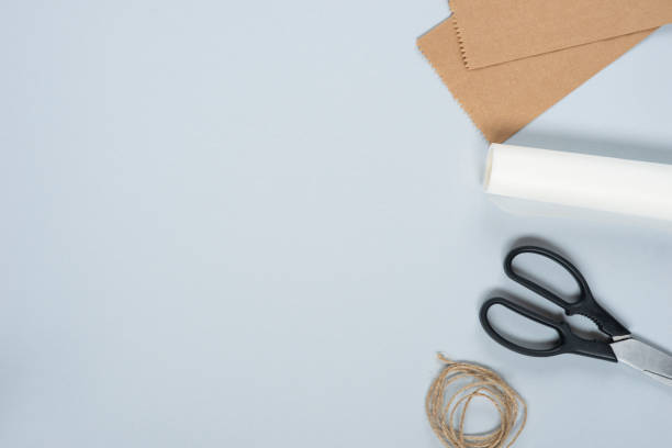 istock Trendy diy crafting background for handmade. Tool set with paper, scissors and rope. For master class or hobby. Light grey background, copy space 1439723250