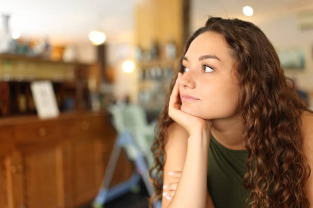 istock Distracted and pensive woman in a restaurant 1439725581