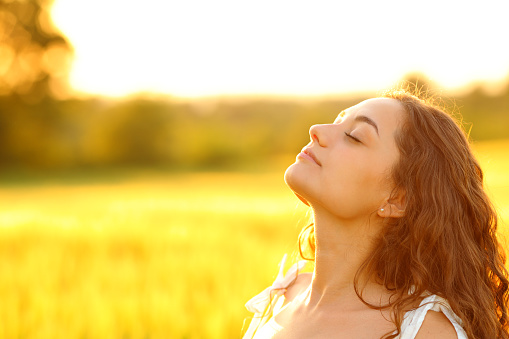 Woman breathing fresh air in a rural environment