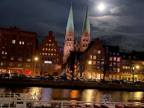 Beautifully illuminated Lübeck with moon in the sky