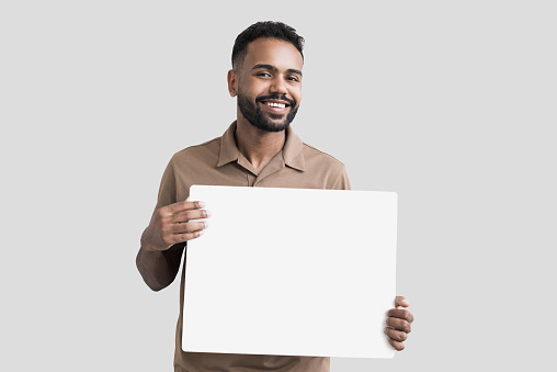 Young man showing billboard sign, advertisement concept