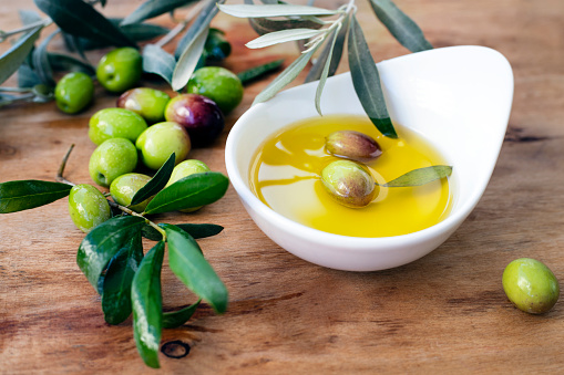Raw green olives and olive oil