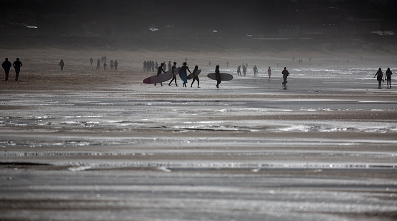 A group of surfers enters the sea at A Lanzada beach, O Grove. surfing course