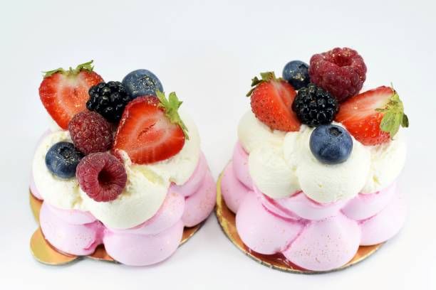 istock Delicious mini Pavlova meringue cakes with fresh berries 1439735697