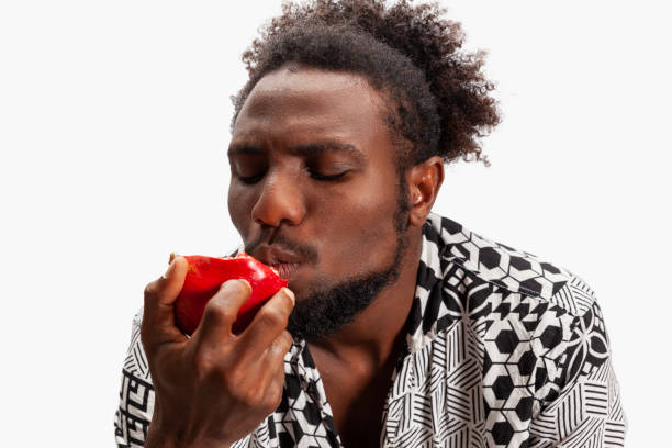 Portrait of men eating pomegranate