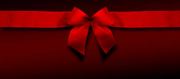 istock Red christmas ribbon on red background 1439738172