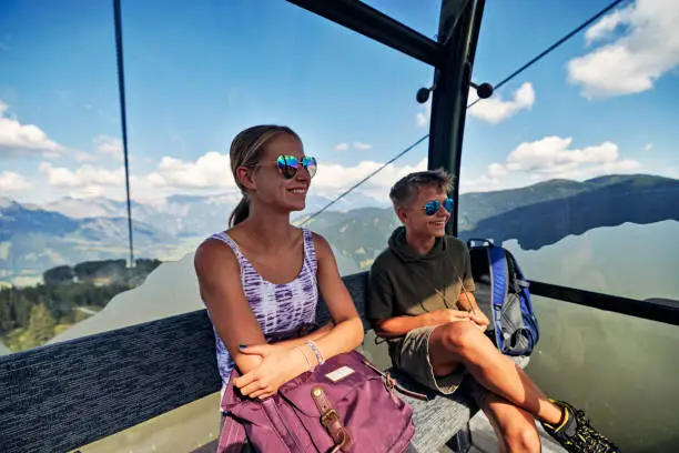 Teenage hikers are using gondola lift cable car. They are looking at the views of European Alps.
Sunny summer day in Salzburg, Austria.
Canon R5