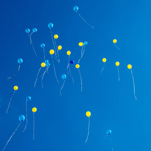 istock Blue and yellow balloons in the blue sky 1439741388
