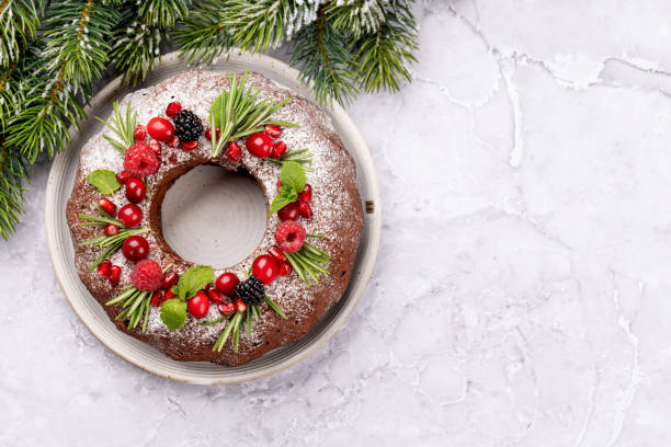 istock Christmas cake with pomegranate seeds, cranberries and rosemary 1439744400