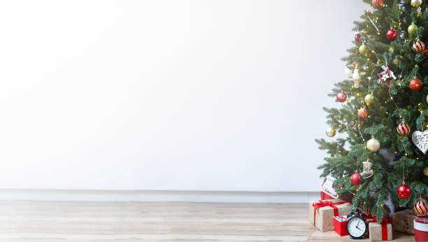 istock Christmas tree decorated with garlands on a white background with space for a copy. 1439748560