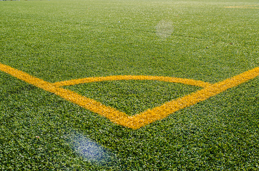 Artificial soccer green turf with yellow lines