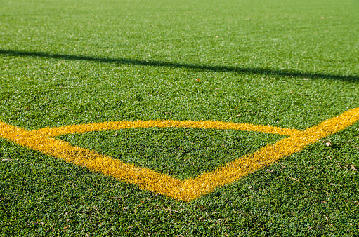 Artificial soccer green turf with yellow lines