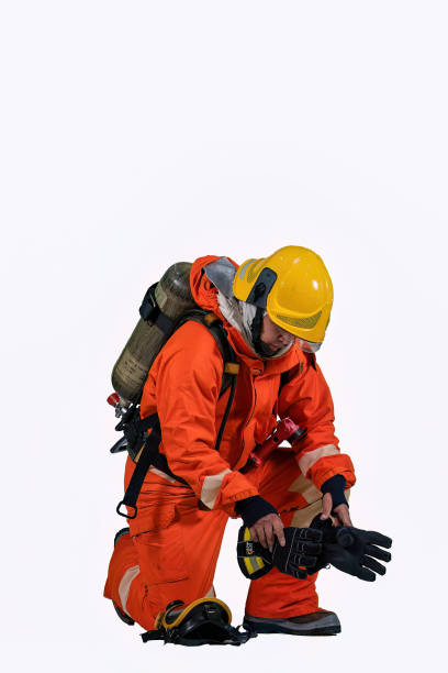 istock Fire man wearing fire protection suite and oxygen tank demonstration dressing on white background 1439752030