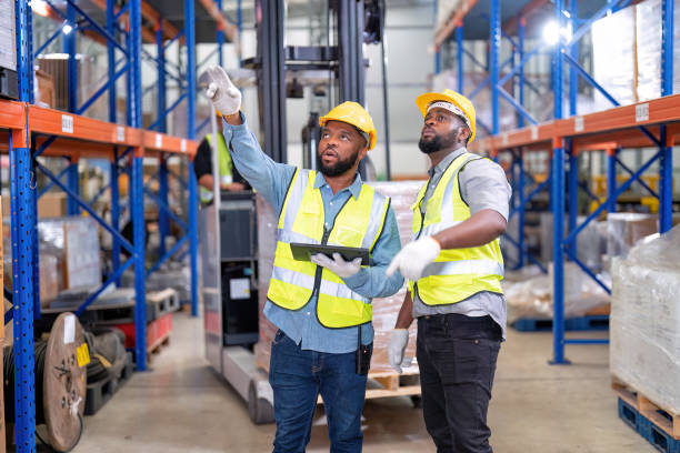 african american working in warehouse hold red light give signal to truck loading carton box - african descent factory accuracy analyzing imagens e fotografias de stock