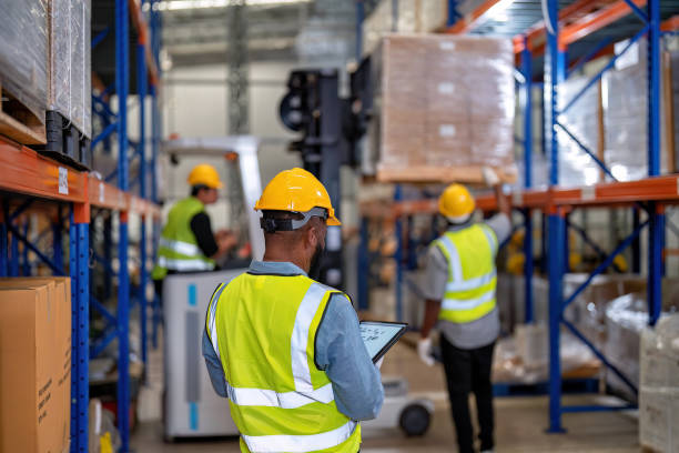 african american working in warehouse hold red light give signal to truck loading carton box - african descent factory accuracy analyzing imagens e fotografias de stock