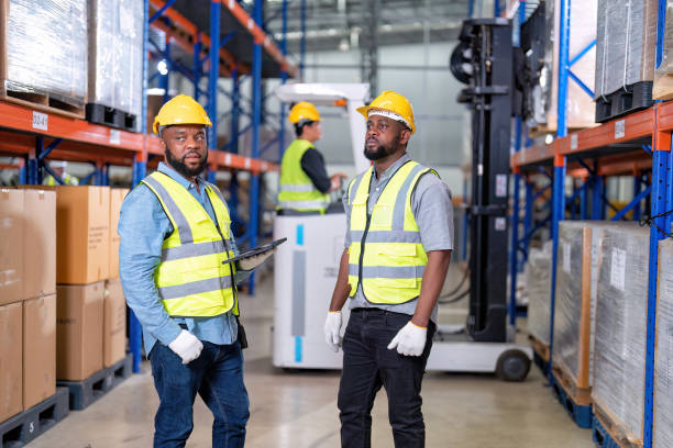 african american working in warehouse hold red light give signal to truck loading carton box - african descent factory accuracy analyzing imagens e fotografias de stock