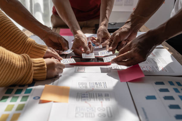 istock Group of ux developer and ui designer brainstorming about app interface design at modern office. Creative digital development agency 1439752569