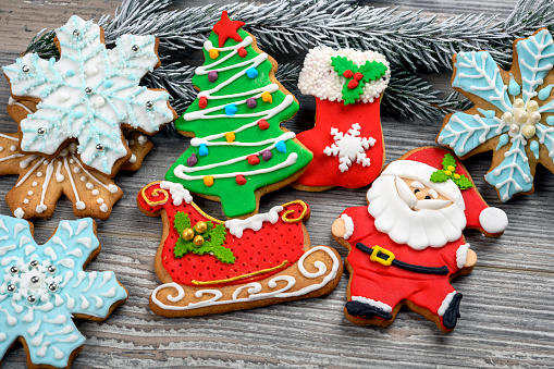 Christmas sugar and gingerbread cookies decorated with royal icing on a plate overhead