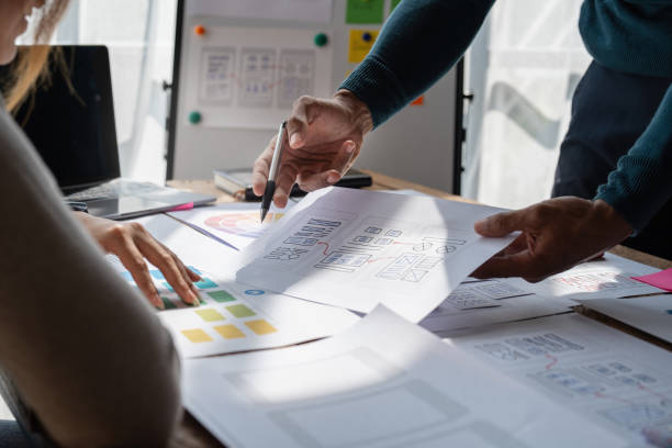 istock Group of ux developer and ui designer brainstorming about app interface design at modern office. Creative digital development agency 1439752653