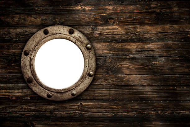 istock Empty Old Porthole Window on Old Wooden Background 1439753327