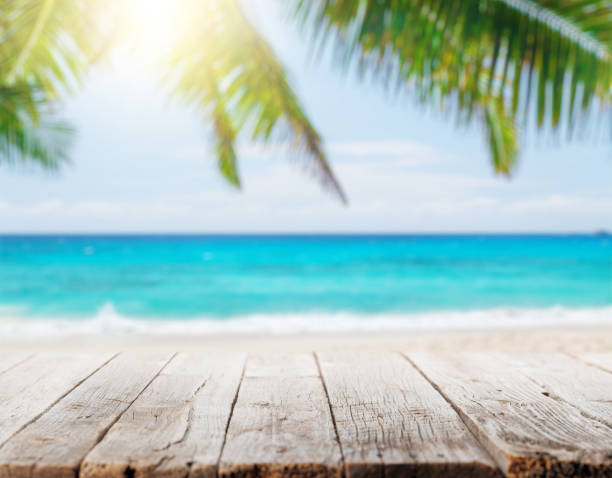 istock Empty wooden table or pier with sunny beach and sea 1439754145