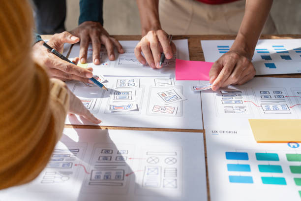 istock Group of ux developer and ui designer brainstorming about app interface design at modern office. Creative digital development agency 1439757109