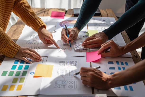 istock Group of ux developer and ui designer brainstorming about app interface design at modern office. Creative digital development agency 1439757402