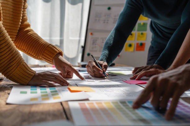 istock Group of ux developer and ui designer brainstorming about app interface design at modern office. Creative digital development agency 1439757601
