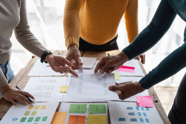 istock Group of ux developer and ui designer brainstorming about app interface design at modern office. Creative digital development agency 1439758070