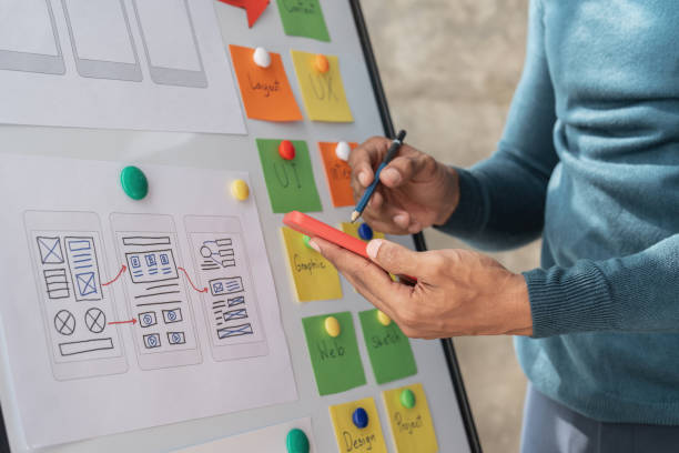 istock Group of ux developer and ui designer brainstorming about app interface design at modern office. Creative digital development agency 1439758738