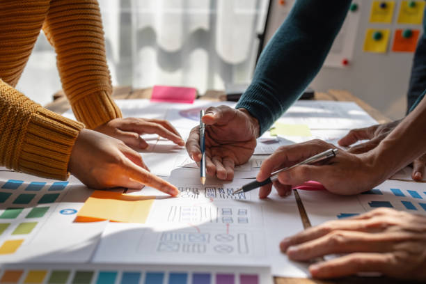 istock Group of ux developer and ui designer brainstorming about app interface design at modern office. Creative digital development agency 1439758808