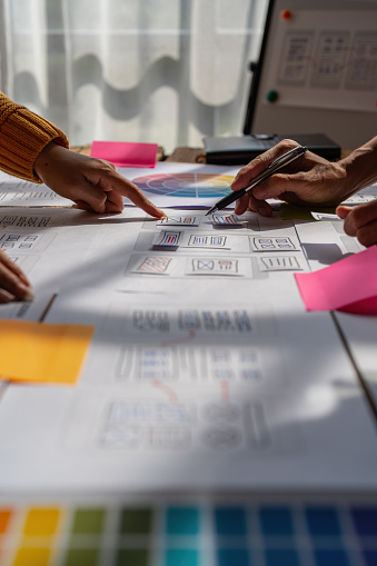 Group of ux developer and ui designer brainstorming about app interface design at modern office. Creative digital development agency.