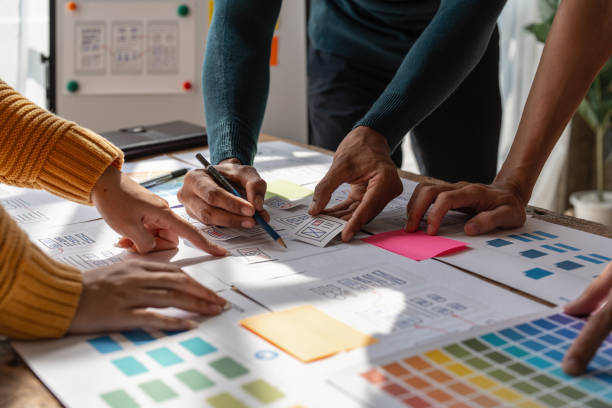 istock Group of ux developer and ui designer brainstorming about app interface design at modern office. Creative digital development agency 1439759764