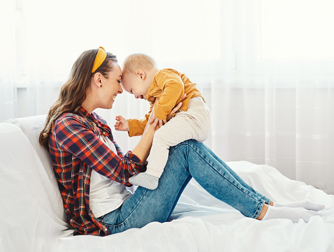 Portrait of a mother and son having fun together at home