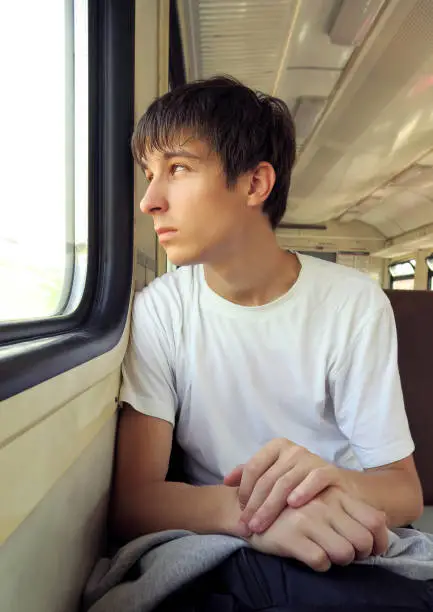 Pensive Young Man sit in the Train