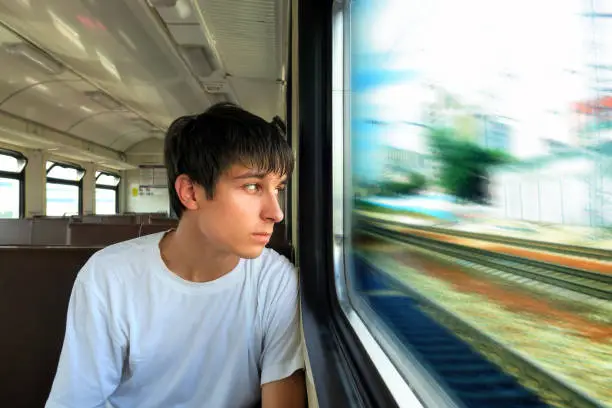 Pensive Teenager sit in the Train