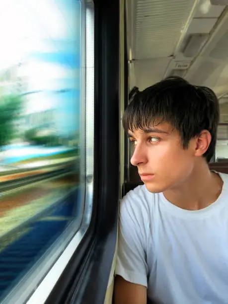 Teenager sit in the Train by the Window