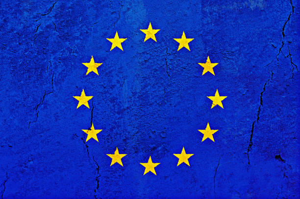flag of the european union, on a cracked rough sandstone surface - european union flag european community photography textured effect imagens e fotografias de stock