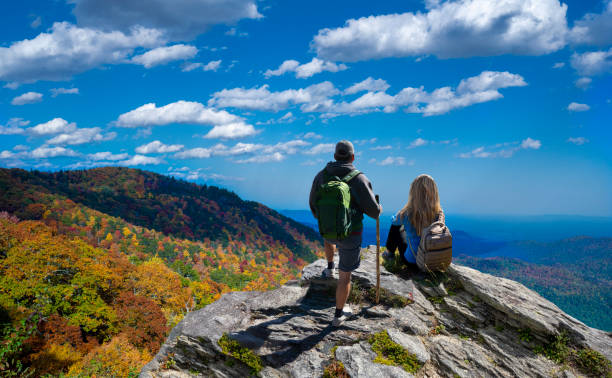 Couple relaxing on the autumn hiking trip in the mountains. stock photo