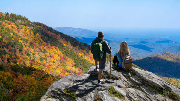 istock Couple looking at the beautiful autumn mountain view. 1439763058