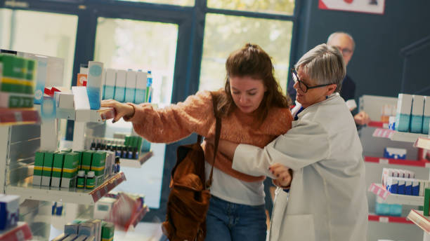 Female client fanting in pharmacy and feeling off Female client fanting in pharmacy and feeling off, almost falling down and having vertigo sensation. Woman losing consciousness and balance near shelves, asking for assistance. Dutch angle. fainted stock pictures, royalty-free photos & images