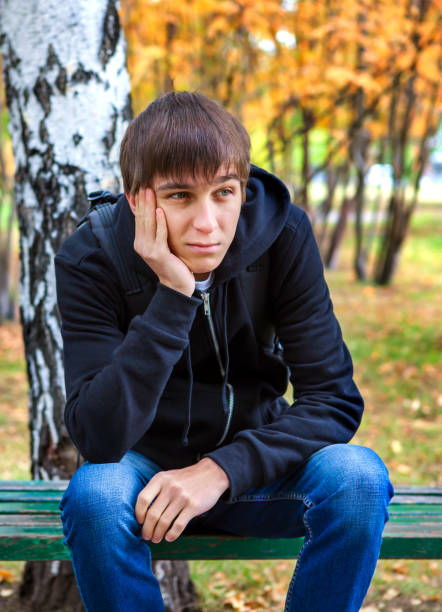 istock Pensive Young Man outdoor 1439765588