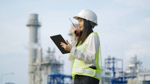 istock Industrial engineer using digital tablet for work against the background of electrical power plant. 1439766517