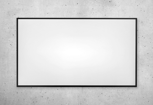 Smart tv screen with white screen on on gray concrete wall